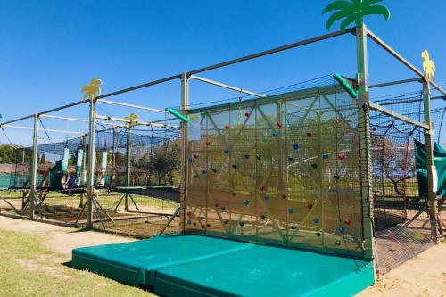 a climbing frame in a playground with a rock wall at HerGine in Pérols