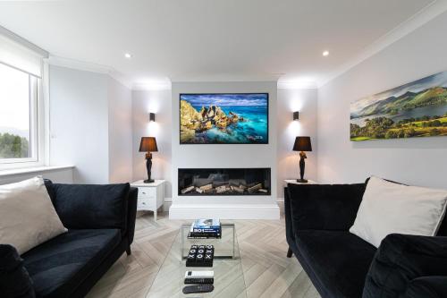 a living room with a couch and a fireplace at Stunning 2 bedroom Apartment in Central Keswick in Keswick