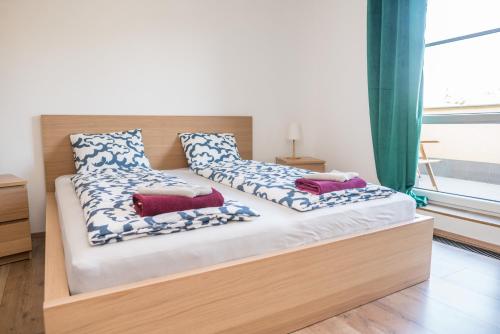 a bed with two pillows on it in a room at Apartmá Kateřina Velké Losiny in Velké Losiny
