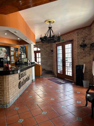 a lobby of a restaurant with a brick wall at HOTEL COLONIAL MATAMOROS in Matamoros