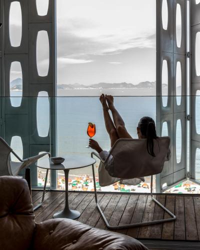 a woman laying in a chair with a beach ball at Emiliano Rio in Rio de Janeiro