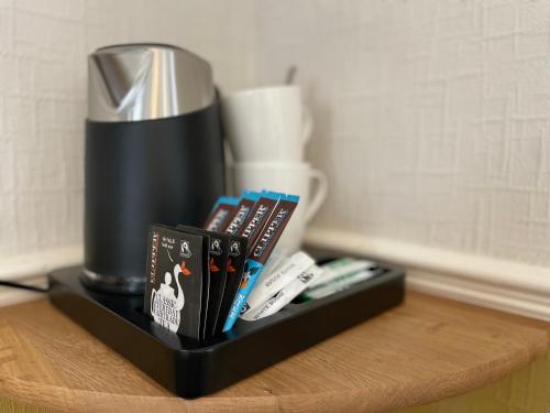 a black shelf with a group of books on a table at Wedgwood Hotel, Orme Room in Llandudno
