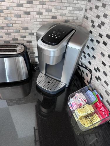 a coffee machine in a kitchen with a counter at BBQ Grill 5 mins to DT Canyon Views Parking in San Diego