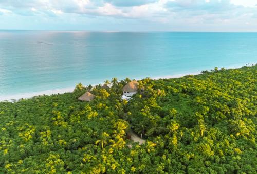an aerial view of a resort on a hill next to the ocean at Sol Caribe in Punta Allen
