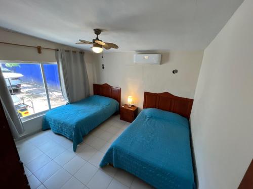 Ένα ή περισσότερα κρεβάτια σε δωμάτιο στο Family home with private pool, Casa Palapa