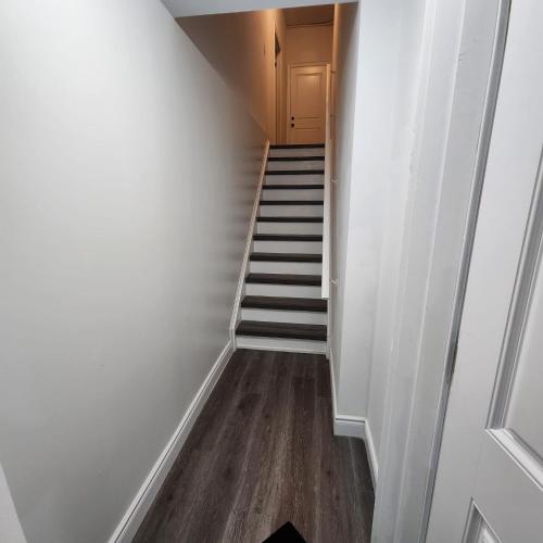 a hallway with a staircase with a stair case at Gracy's property in Thamesford