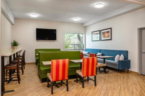 a restaurant with colorful chairs and tables and a tv at Comfort Inn & Suites in Barrie