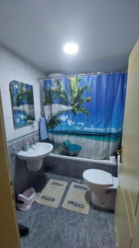 a bathroom with a sink and a toilet and a window at Apartman Dona in Jagodina