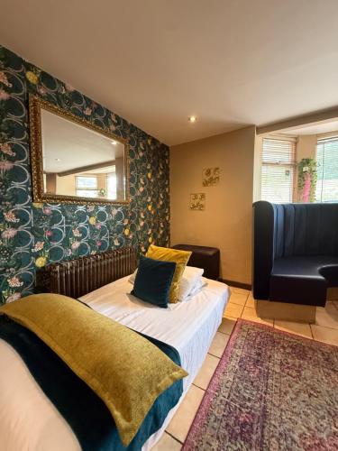 a bedroom with a bed and a mirror and a chair at The Bunk House in South Shields