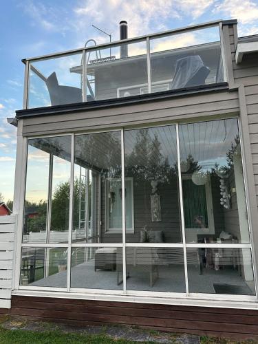 a conservatory with glass doors on a house at Virpiniemen Maston Villa, Oulu in Oulu