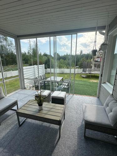 a screened in porch with a table and chairs at Virpiniemen Maston Villa, Oulu in Oulu