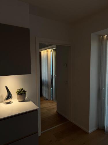 a living room with a vase on a counter and a hallway at Lighthouse på Ø - Panoramaudsigt in Aarhus