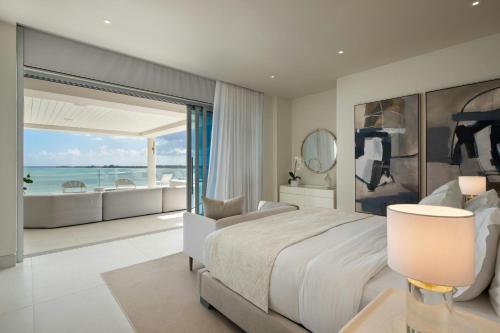 a bedroom with a bed and a view of the ocean at St. Regis Bahia Beach Resort, Puerto Rico in Rio Grande