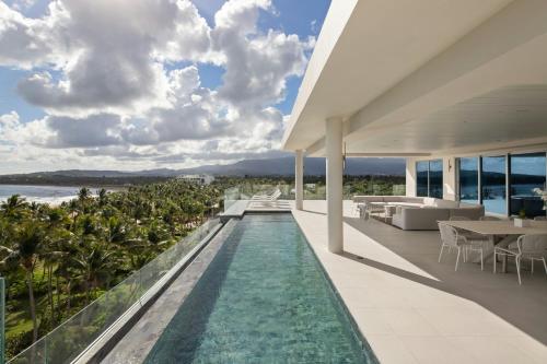 an infinity pool in a villa with a view of the ocean at St. Regis Bahia Beach Resort, Puerto Rico in Rio Grande