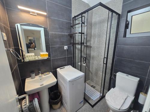 a bathroom with a toilet and a sink and a shower at Olive trees in Budva