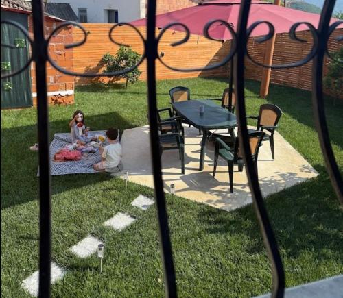 a woman and child sitting on a blanket in the grass at VILA Moreja in Berat