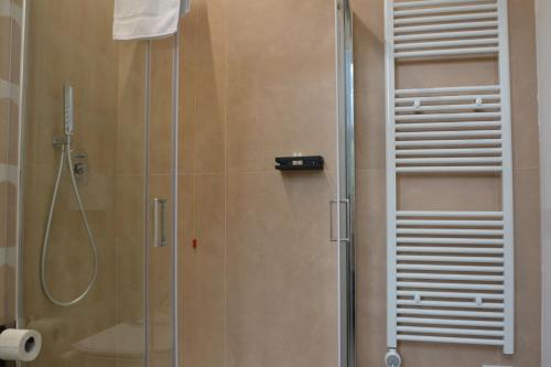 a shower with a glass door in a bathroom at Le camere in città in La Spezia