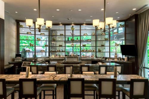 a restaurant with tables and chairs and a bar at Sheraton Grand Seattle in Seattle