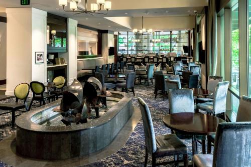 a restaurant with a fireplace and tables and chairs at Sheraton Grand Seattle in Seattle