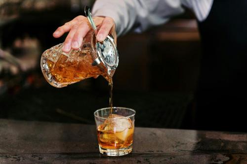 a person pouring a drink into a glass at Sheraton Grand Seattle in Seattle
