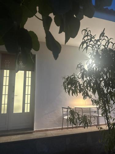 a bench sitting in front of a building with a door at Mater in Capilungo