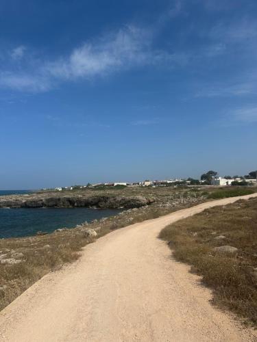 a dirt road next to a body of water at Mater in Capilungo