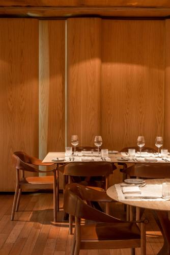 a dining room with tables and chairs with wine glasses at Emiliano Rio in Rio de Janeiro