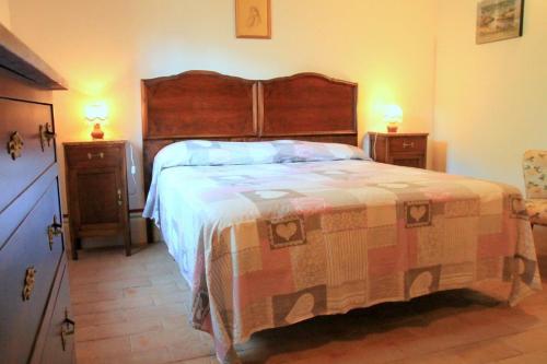 a bedroom with a large bed and two night stands at Villa del Poggio in Poggio Mirteto