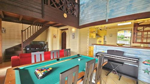 a room with a pool table in a house at VILLA La Suite Viva Vero in Les Trois-Îlets