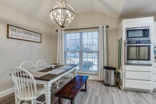 a dining room with a table and a microwave at Family-Friendly Fun, Pool, Game Room, DFW Airport in Lewisville