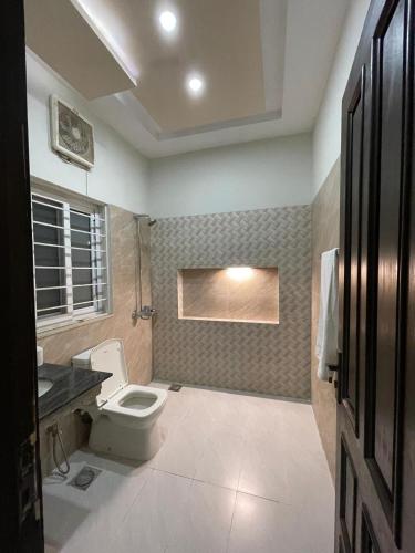 a bathroom with a toilet and a sink at Islamabad Family Residence in Islamabad