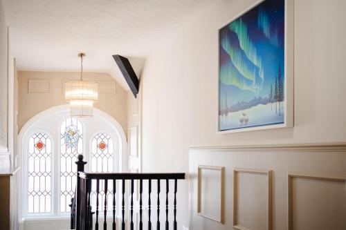 a staircase with a window and a picture on the wall at The Yorkshire Unicorn in Skipton