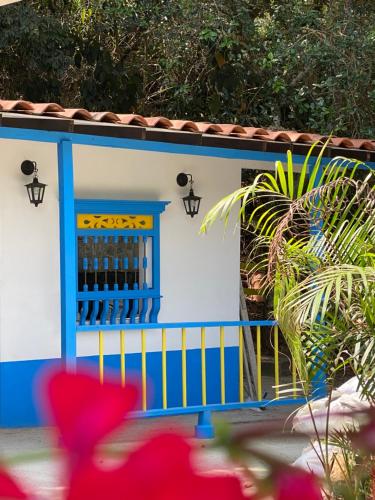 a blue and white house with a gate and a plant at El Refugio in Copacabana