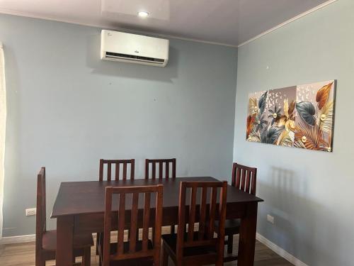 a dining room with a table and chairs and a air conditioner at Villas Carari in Hatillo