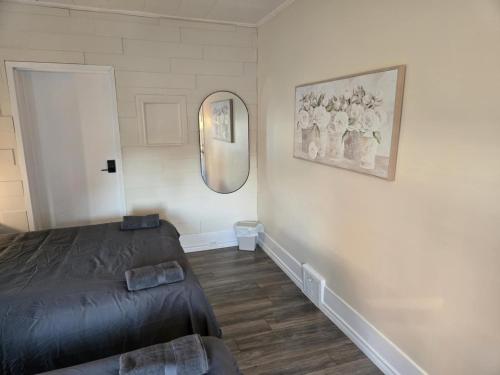 a bedroom with a bed and a mirror on the wall at Byward Market Downtown Guesthouse in Ottawa