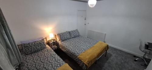 a small bedroom with a bed and a lamp at Plymouth Airbnb in Plymouth