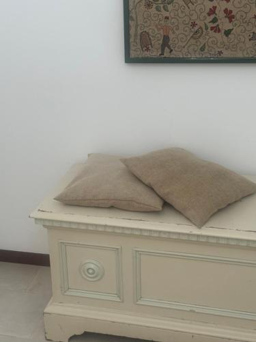 a white table with two pillows on top of it at Percebes Exclusive B&B in Cutrofiano