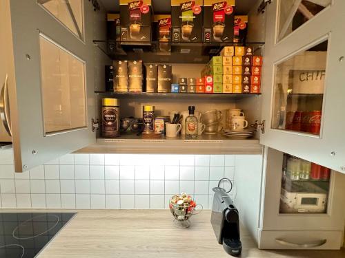 a kitchen with a cupboard with spices and a bowl of fruit at Riverfront house with 98 inch TV, ps5 & activities in Narvik