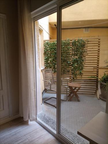 a sliding glass door with a chair on a patio at Hostal Quiper in Quiroga