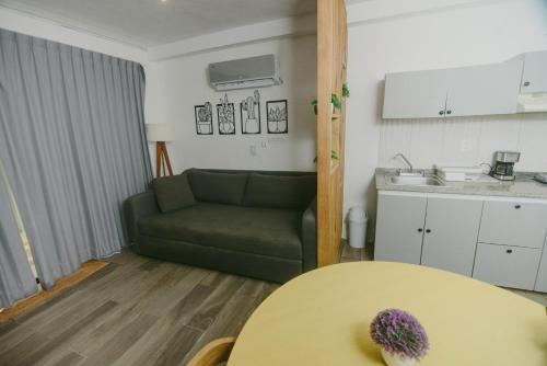 a living room with a green couch and a table at HotelZone L20 Beach Access in Cancún