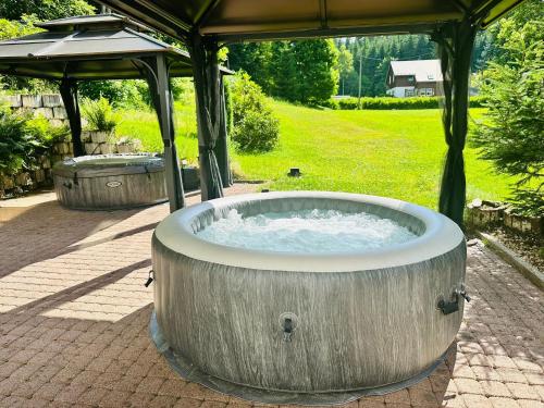 a hot tub in a gazebo in a yard at Garden Depandance Am Bach in Kurort Altenberg