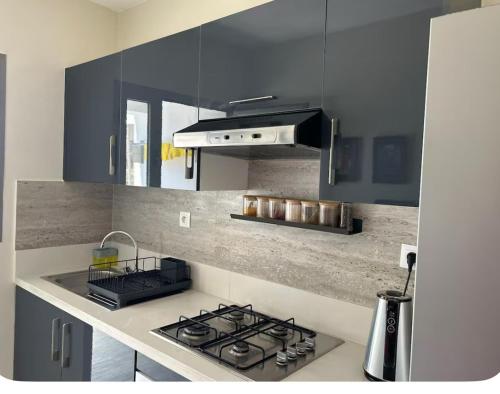 a kitchen with a stove and a stove top oven at Escapade chic & cosy à Cabo in Cabo Negro