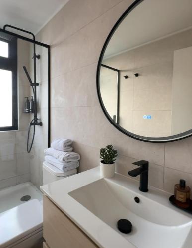 a bathroom with a sink and a mirror at LUUM by Norus in Santiago