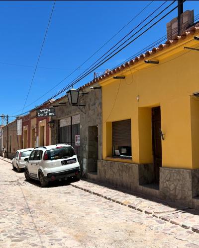 a car parked on a street next to a building at La Churita 2 - EL GUALICHO HOSTAL in Humahuaca