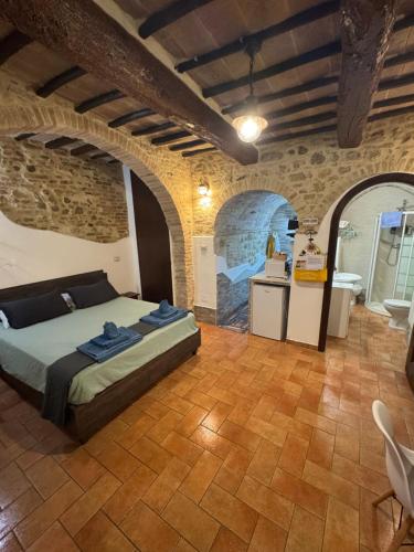 a bedroom with a bed and a kitchen in a building at Casa Leon - City center in Perugia
