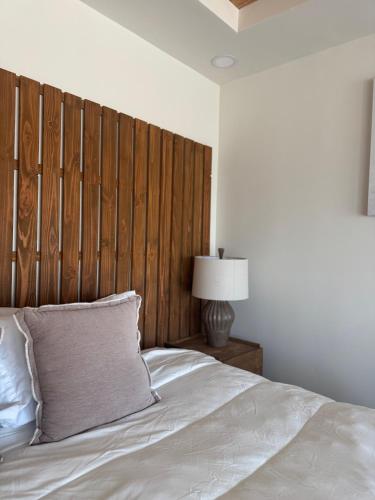 a bed with a wooden headboard in a bedroom at Maple Resort in Santa Rosa