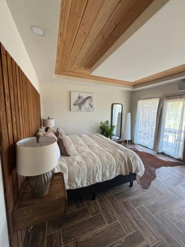 a bedroom with a large bed with a wooden ceiling at Maple Resort in Santa Rosa