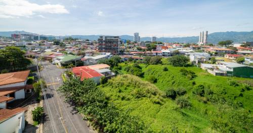 an aerial view of a city with buildings at BEE Suites San José - Escalante in San José