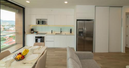 a kitchen with a table with bananas on it at BEE Suites San José - Escalante in San José