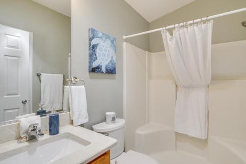 a white bathroom with a sink and a toilet at 4 Mi to Lake Sumter Landing Home in The Villages in The Villages